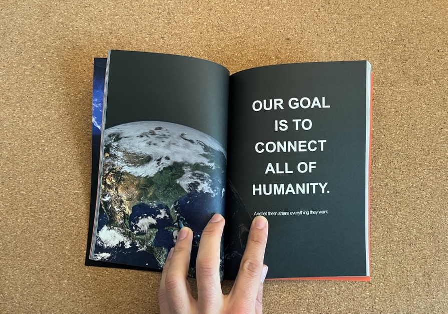 A hand holding a book open